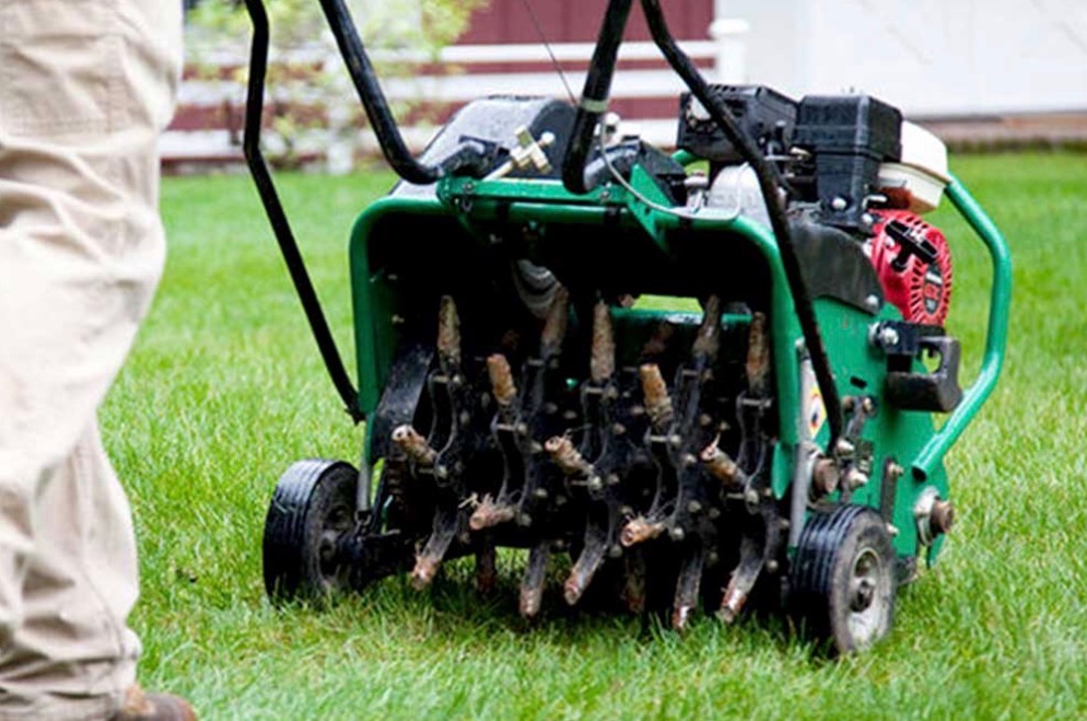Aeration machine improving soil health on a residential lawn